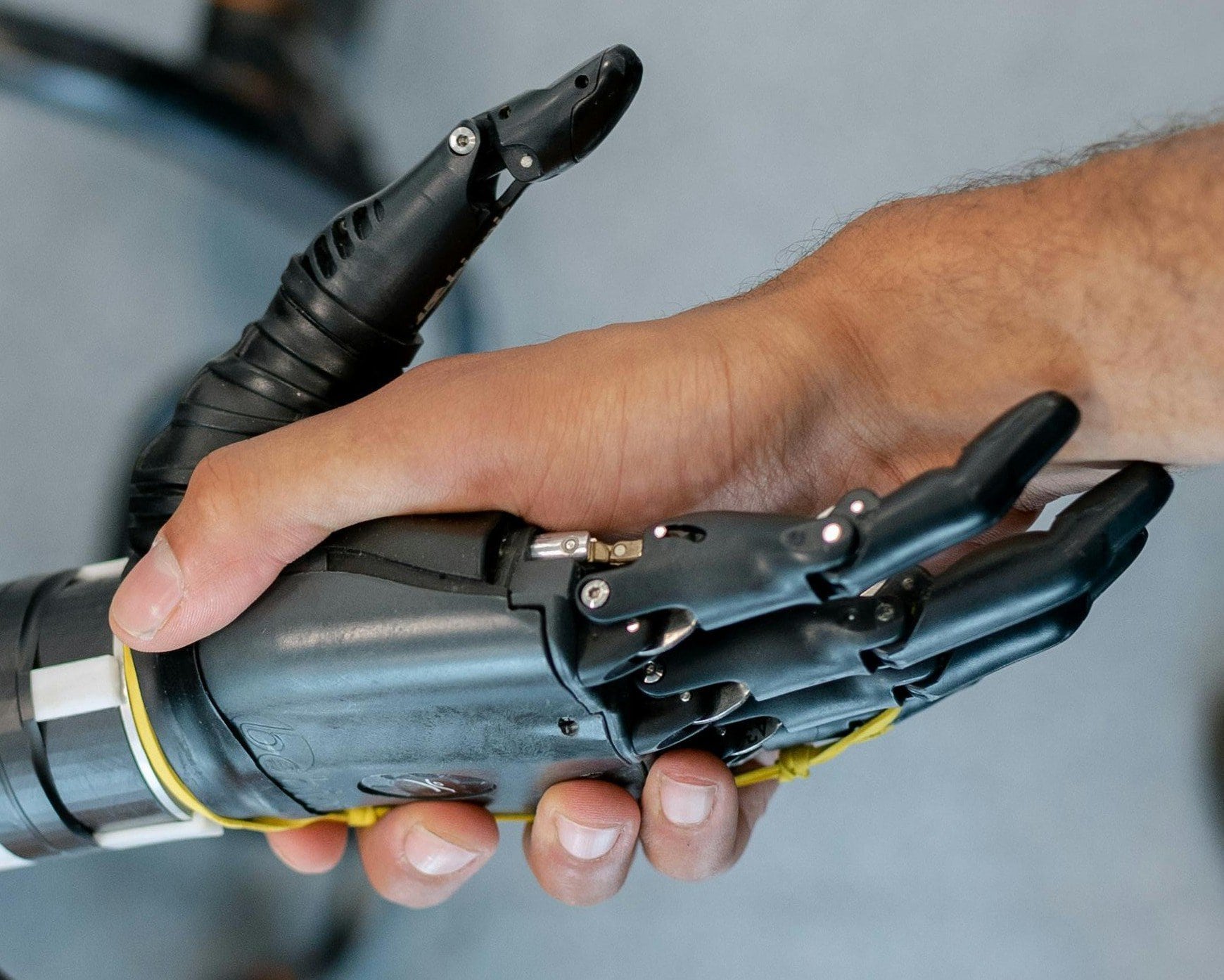 A professional handshake between a human and a robot, representing AI in Marketing Management and human-centric strategy.